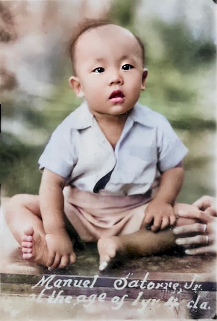 Hand-tinted studio portrait of Manuel Satorre Jr. as a toddler, captioned: 'Manuel Satorre Jr., at the age of 1 yr & 4 mos.'